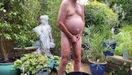Pissing by tube stripped in garden